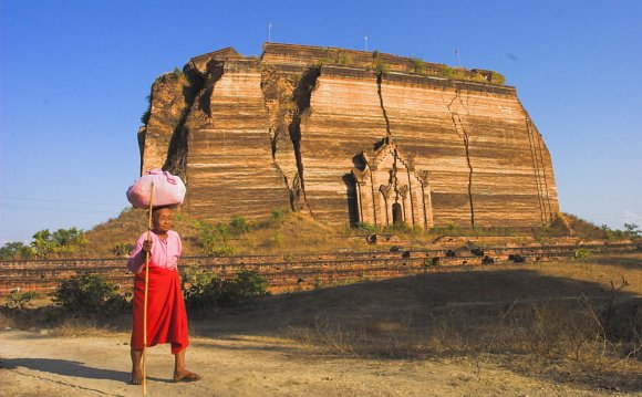 Elderly nun walks past paya