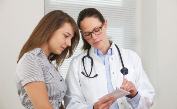 Doctor showing notes to young