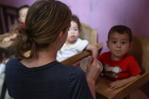 A Costa Rican son or daughter enjoys meals with a tasks overseas volunteer