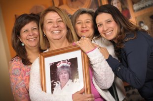 set of women holding a framed photo